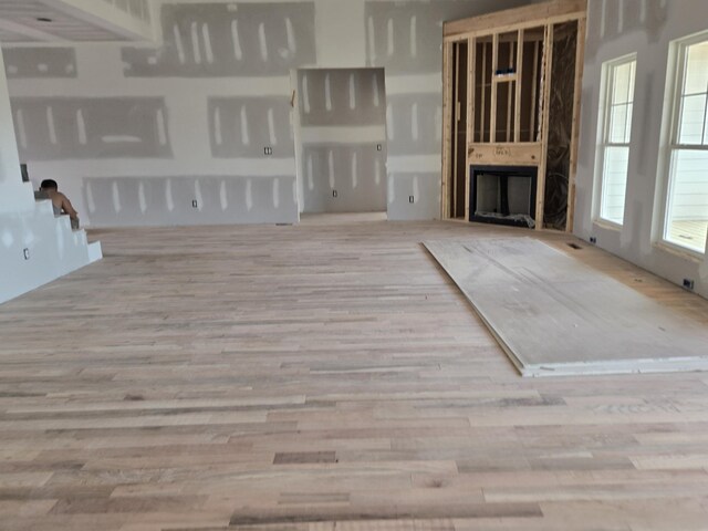 unfurnished living room with a fireplace and wood finished floors