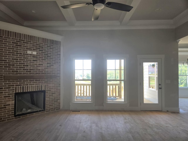 10634 Flicker Way Unit 119, Apison, TN 37302 - unfurnished living room with wood finished floors, a ceiling fan, beamed ceiling, coffered ceiling, and a brick fireplace