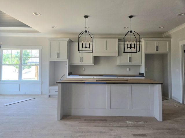 10634 Flicker Way Unit 119, Apison, TN 37302 - kitchen with white cabinetry, light wood-type flooring, a center island, recessed lighting, and crown molding