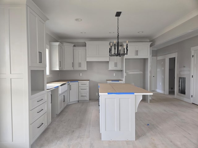 10630 Flicker Way Unit 120, Apison, TN 37302 - kitchen with a center island, light wood finished floors, white cabinetry, a chandelier, and hanging light fixtures
