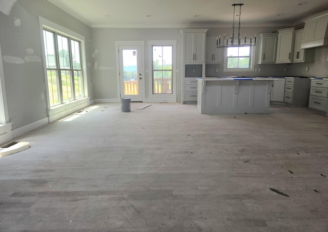 10630 Flicker Way Unit 120, Apison, TN 37302 - kitchen featuring a center island, open floor plan, ornamental molding, hanging light fixtures, and light wood finished floors