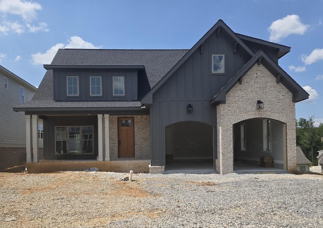 10630 Flicker Way Unit 120, Apison, TN 37302 - view of front of home featuring board and batten siding, roof with shingles, brick siding, and covered porch