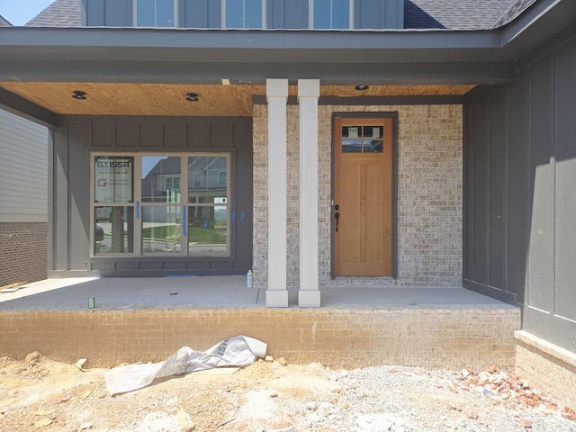 10630 Flicker Way Unit 120, Apison, TN 37302 - entrance to property featuring board and batten siding, a porch, a shingled roof, and brick siding