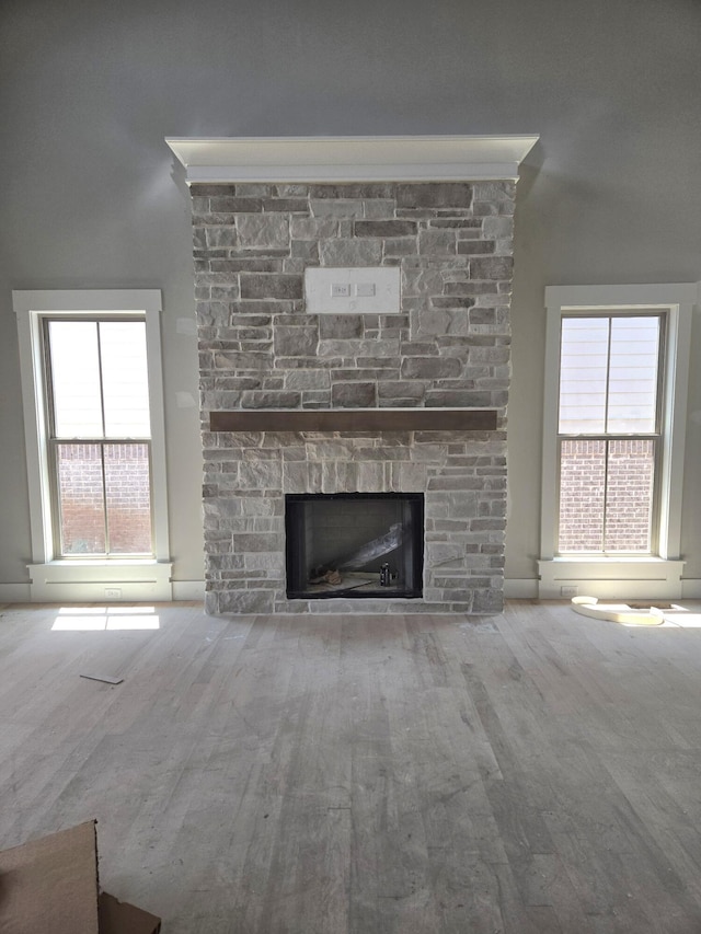 10630 Flicker Way Unit 120, Apison, TN 37302 - unfurnished living room featuring a stone fireplace, wood finished floors, and plenty of natural light