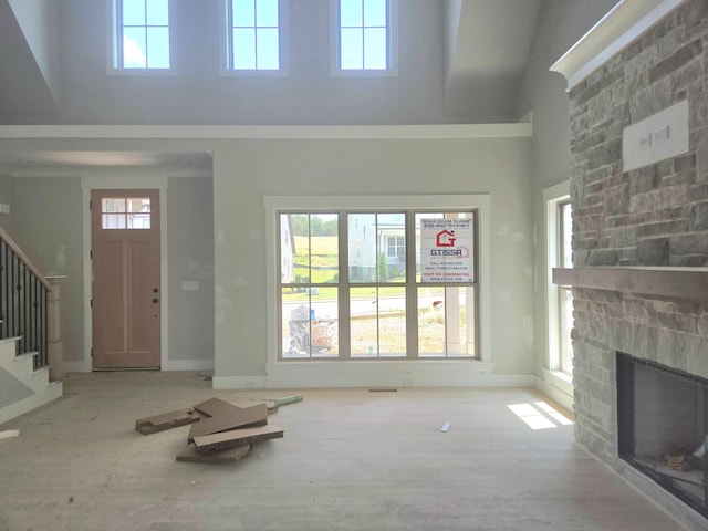 10630 Flicker Way Unit 120, Apison, TN 37302 - unfurnished living room featuring stairway, a towering ceiling, healthy amount of natural light, and a fireplace