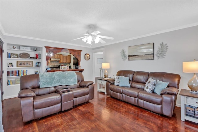 living room featuring built in shelves, ornamental molding, ceiling fan, a textured ceiling, and wood finished floors