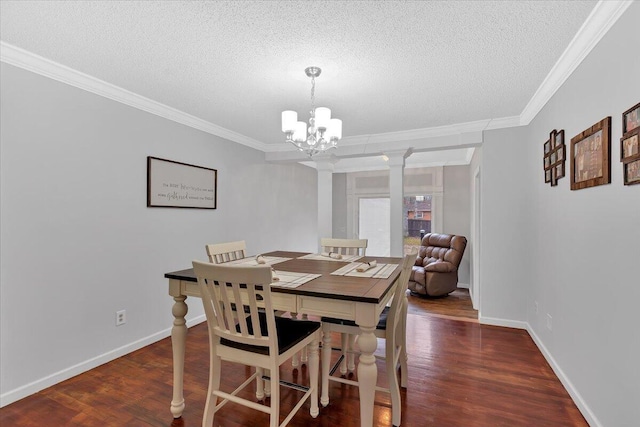 dining room with a chandelier, crown molding, and wood finished floors