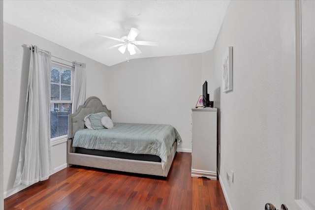 bedroom featuring a ceiling fan, baseboards, and wood finished floors