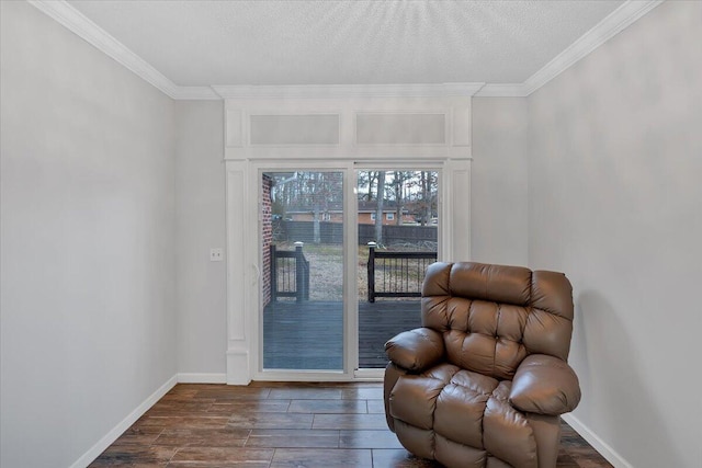 living area featuring dark wood-style floors, baseboards, ornamental molding, and a textured ceiling