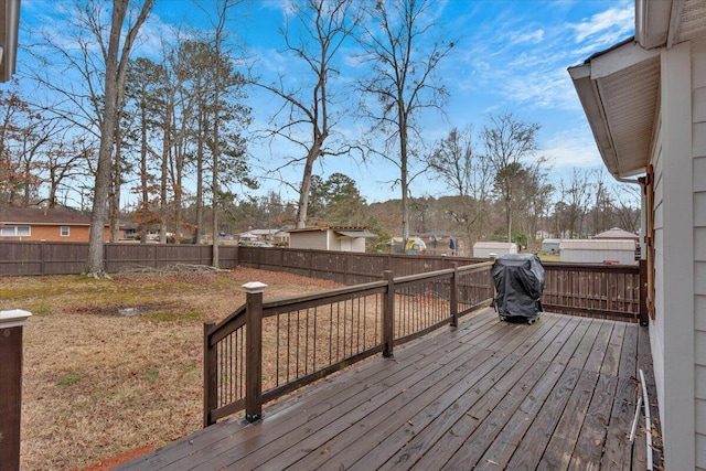 deck with a fenced backyard and grilling area