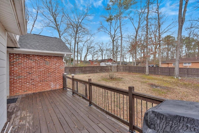 deck with a fenced backyard and a yard