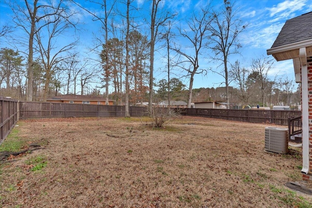 view of yard featuring central air condition unit and a fenced backyard