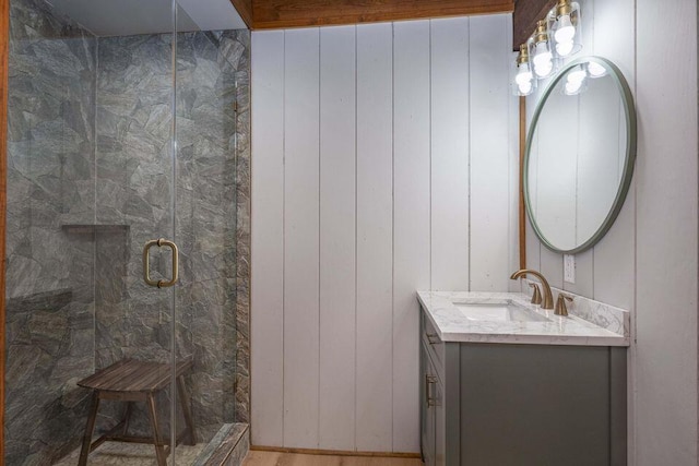 full bathroom with a shower stall and vanity