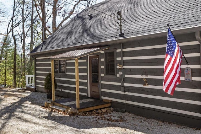 exterior space featuring a shingled roof