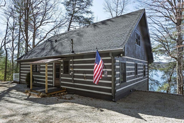 exterior space with roof with shingles