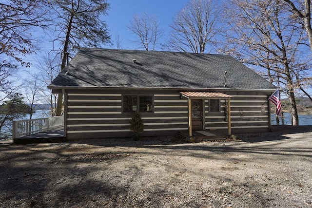 back of property with roof with shingles