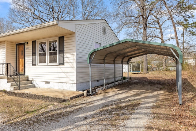 view of parking / parking lot featuring a carport and driveway