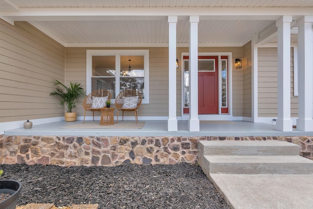 view of exterior entry with a porch