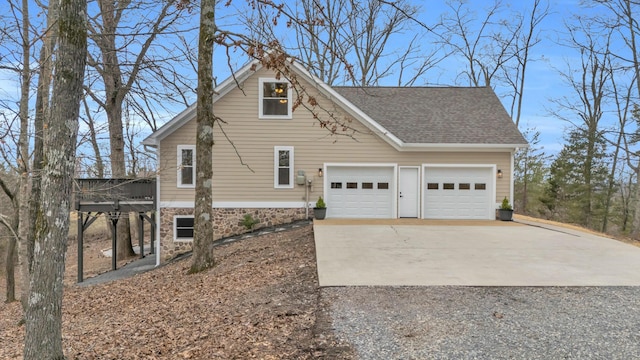 view of property exterior featuring a shingled roof, concrete driveway, and a garage