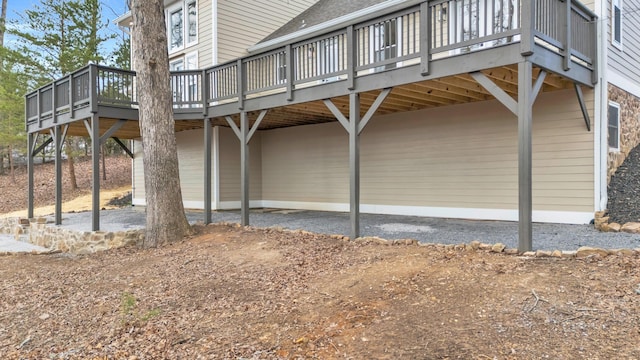 view of side of home featuring a deck, a patio, and a carport