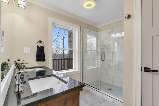 bathroom with a sink, double vanity, and a shower stall