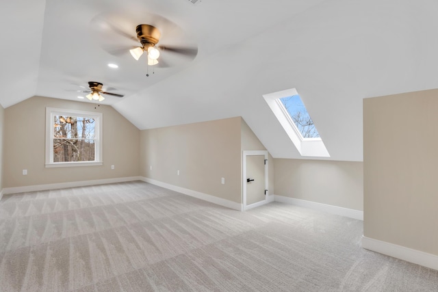 additional living space featuring lofted ceiling, carpet floors, ceiling fan, and baseboards