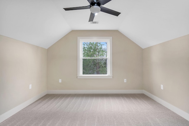 additional living space with vaulted ceiling, carpet floors, visible vents, and baseboards