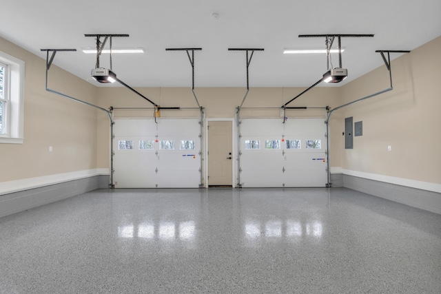 garage featuring a garage door opener and electric panel