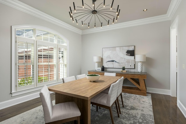 dining space with dark wood finished floors, an inviting chandelier, baseboards, and ornamental molding