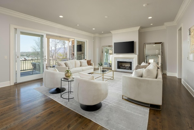 living room featuring dark wood-style floors, baseboards, a high end fireplace, and ornamental molding