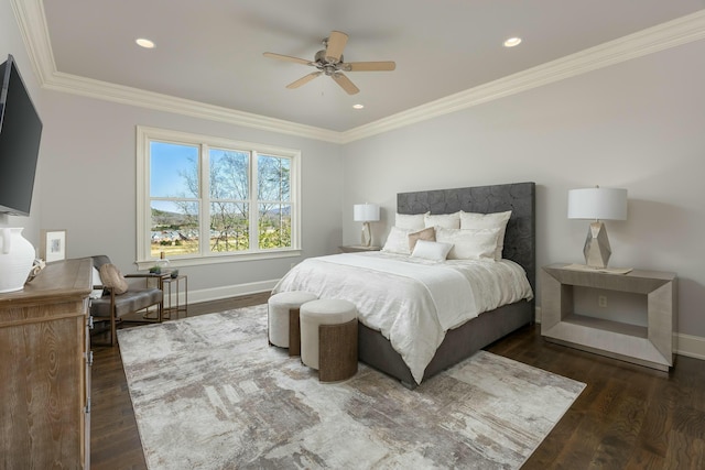 bedroom with crown molding, wood finished floors, and baseboards