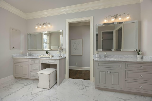 full bath featuring two vanities, ornamental molding, marble finish floor, and a sink