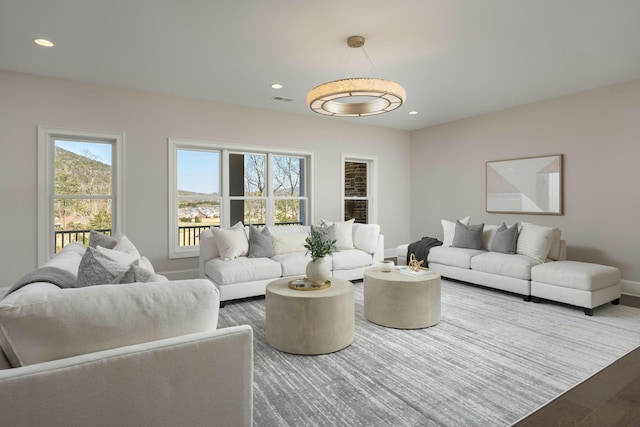 living room with visible vents, recessed lighting, baseboards, and wood finished floors