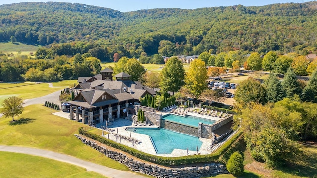 birds eye view of property with a view of trees