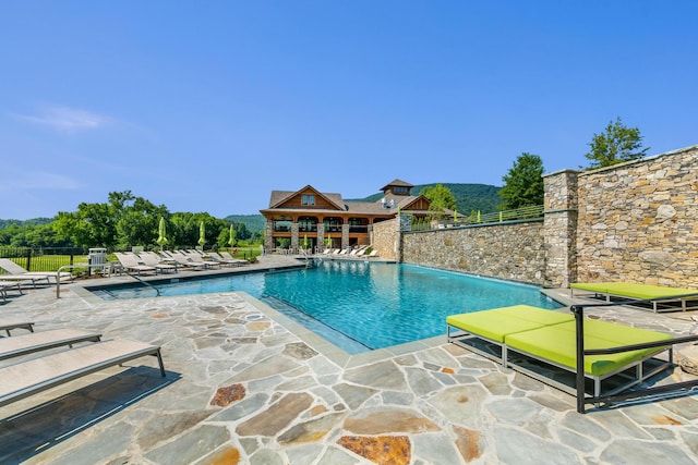 community pool featuring a patio and fence