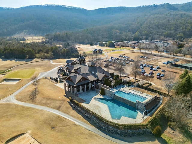 birds eye view of property with a view of trees