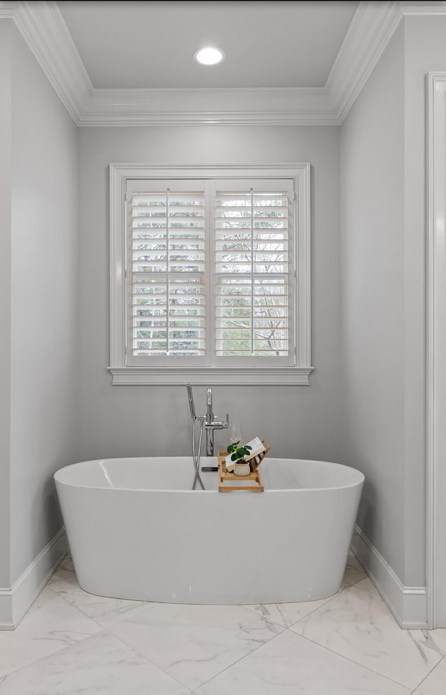 full bathroom with a wealth of natural light, baseboards, and crown molding