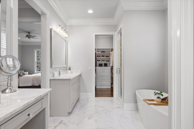 bathroom with marble finish floor, crown molding, a freestanding bath, ceiling fan, and vanity