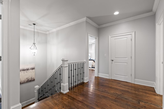 corridor featuring wood finished floors, crown molding, an upstairs landing, and baseboards