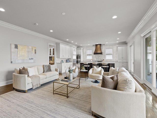 living room featuring crown molding, light wood-style flooring, and recessed lighting