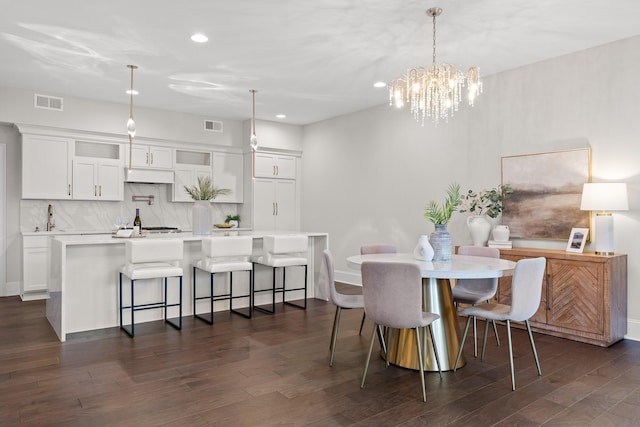 dining space with recessed lighting, visible vents, a notable chandelier, and dark wood-style floors