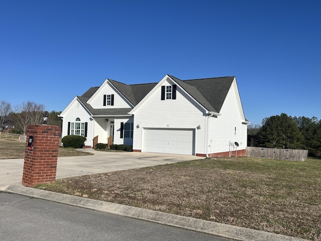 view of front of house with a garage, driveway, a front yard, and fence