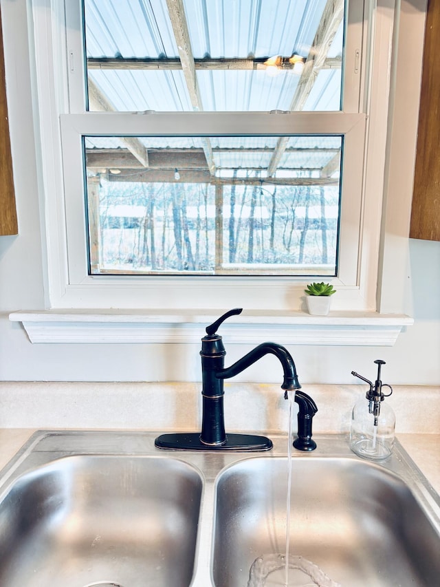 interior details with white cabinetry, light countertops, and a sink