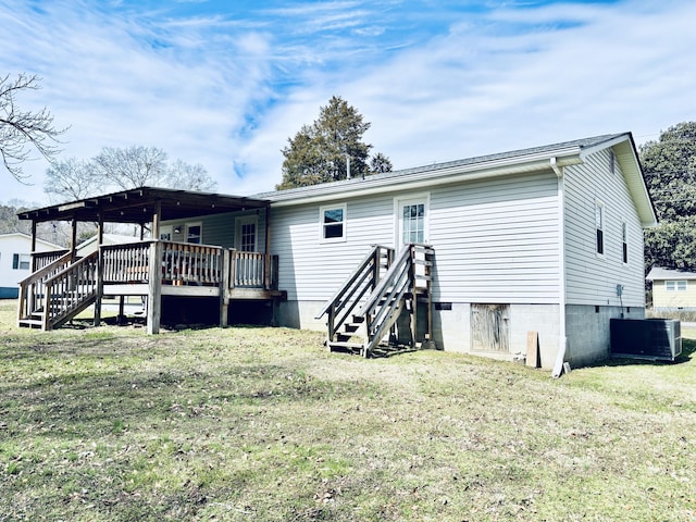 back of property featuring cooling unit, a lawn, and a deck