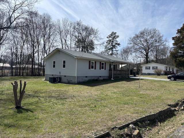 view of side of property featuring crawl space, covered porch, a yard, and central air condition unit