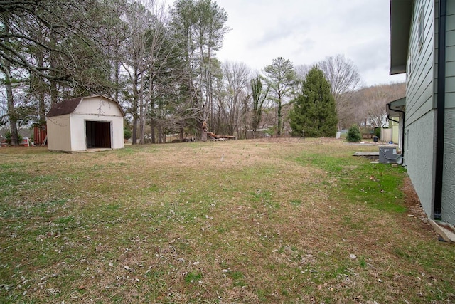 view of yard featuring an outdoor structure, a storage shed, and central air condition unit