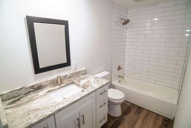 full bath with vanity, shower / washtub combination, wood finished floors, and toilet