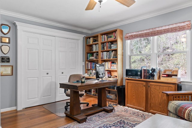 office area featuring baseboards, ceiling fan, ornamental molding, and wood finished floors