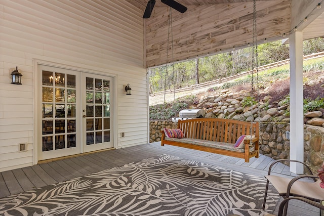 wooden terrace featuring french doors and ceiling fan