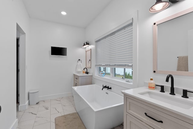 bathroom with recessed lighting, a sink, baseboards, a freestanding bath, and marble finish floor